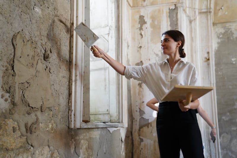 Woman repairing a wall